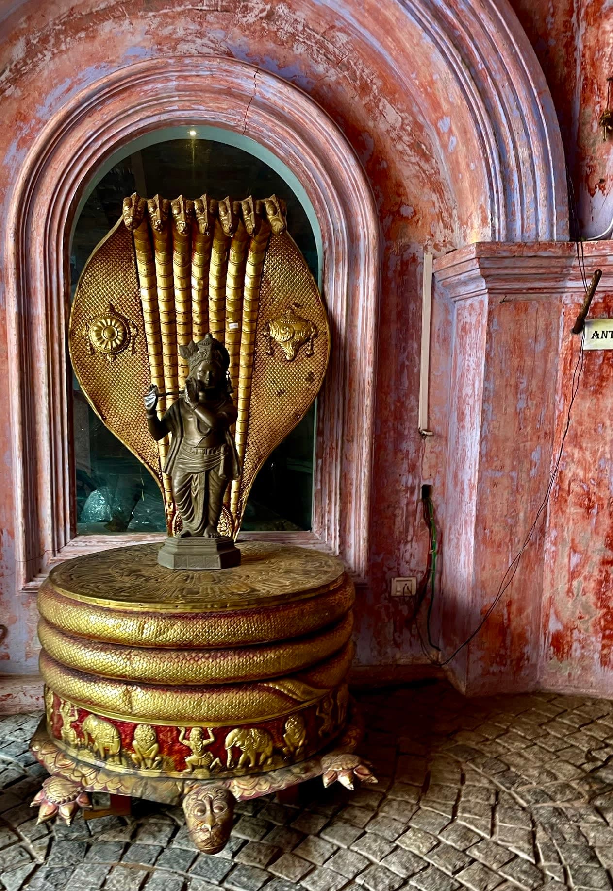 Hindu deity Krishna standing on the serpent king Shesha Naga. 